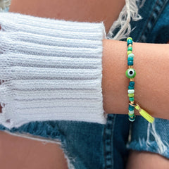 I carry balance and healing energy — Green Evil Eye Beaded Bracelet